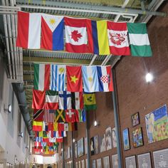 flags hanging from the ceiling in a building