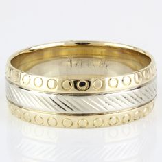 two tone gold and silver wedding bands with black diamond in the center, set on top of each other