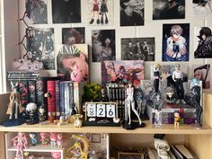 there are many pictures and figurines on the shelf