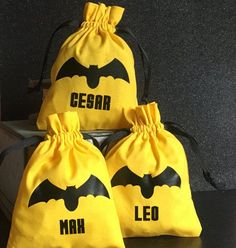 three yellow bags with batman logos on them