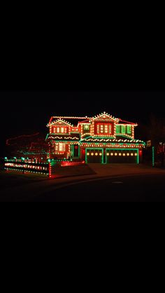 a house covered in christmas lights at night