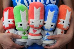 a person holding five stuffed animals in their hands