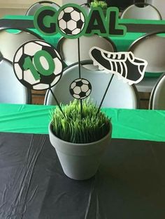 a soccer themed centerpiece with grass in a pot