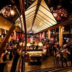 a restaurant filled with lots of people sitting at tables