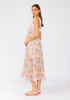 A classic vintage-inspired bohemian midi dress with delicate lace trim detail, designed in a pink floral print. Floral print Relaxed fit Sleeveless Midi length Tiered skirt Square neckline Adjustable tank top straps Button front top Adjustable drawstring tie waist Lace trim Lined Bohemian midi dress Embrace summer with our vintage-inspired bohemian midi dress. This chic piece features a delicate lace trim, adding a touch of elegance to its cute pink floral print. Perfect for warm weather outings. Model is 5'9, wearing a size S.Style: I-73411WL-SPL-RL Spring Flowy Midi Dress With Spaghetti Straps, Flowy Midi Dress With Spaghetti Straps For Spring, Flowy Spaghetti Strap Midi Dress For Spring, Floral Print Midi Sundress For Daywear, Pink Ditsy Floral Print Sundress For Brunch, Floral Print Spaghetti Strap Midi Dress For Daywear, Pink Ditsy Floral Print Sundress For Spring, Spring Pink Lace Maxi Dress, Spring Pink Floral Dress With Lace Trim