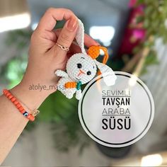 a hand holding a small crocheted animal in it's right hand with the words selimi tafsan araba susu on it