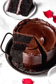 a chocolate cake on a plate with one slice cut out and the rest half eaten