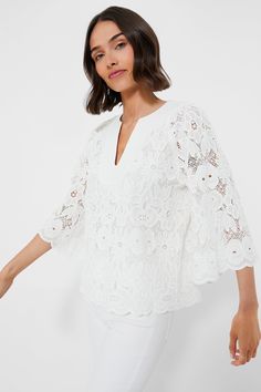 The White Eyelet Lace Florian Blouse is your new summer staple. Crafted from cotton, this top has an elegant notched neckline with stitch detailing, capacious three-quarter length sleeves and an eyelet floral design that leads into a scalloped cuffs and hem. Pair with a white denim and strappy sandals for a chic mono-tone look that will turn heads. Notched neckline Trapunto stitching at collar Three-quarter length bell sleeves Scalloped cuffs and hem Slightly boxy Embroidered lace fabric Lined b Spring V-neck Top With Scalloped Lace, Feminine Spring Top With Cutwork Hem, Feminine Spring Tops With Cutwork Hem, Chic Spring Tops With Cutwork Hem, Fitted Blouse With Cutwork Hem For Spring, Spring Scallop Lace Top For Daywear, Elegant Spring Top With Cutwork Hem, Spring Scalloped Lace Top For Daywear, Spring Daywear Blouse With Cutwork Hem