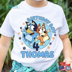 a young boy wearing a birthday t - shirt with cartoon characters on it