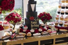 a table topped with lots of cupcakes and cakes