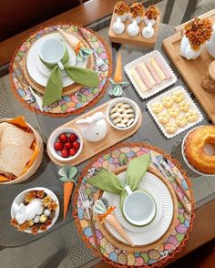 the table is set with many different foods