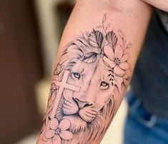 a lion with a cross and flowers on its arm