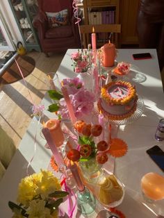 a table topped with lots of cakes and candles