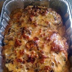 a casserole dish with meat and cheese in it