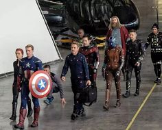 the avengers are walking down the runway with their captain's gear in front of them