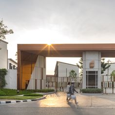 a person walking down the street in front of a building