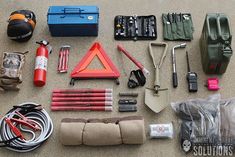 an assortment of tools and equipment laid out on the ground next to each other,