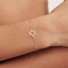 1- P R O D U C T ∙  D E S C R I P T I O N Get this stylish Diamond Star of David Bracelet, a unique blend of faith and fashion. Handcrafted in 14k solid gold, this dainty Jewish Star bracelet features bezel-set diamonds, adding a touch of elegance to your everyday style. Perfect as a heartfelt gift or a personal treat, this delicate 14k gold diamond by the yard bracelet is a testament to timeless beauty and spiritual strength. 2- P R O D U C T ∙  D E T A I L S Diamond quality: * Diamond Type: Na 14k Gold Star-shaped Bracelet Gift, 14k Gold Star Bracelet Gift, 14k Gold Star Charm Bracelet, 14k Gold Bracelets With Star Charm, 14k Gold Dainty Bracelet With Star Charm, Dainty 14k Gold Bracelet With Star Charm, 14k Yellow Gold Bracelet With Star Charm, Elegant 14k Gold Star Of David Jewelry, White Gold Star Of David Jewelry