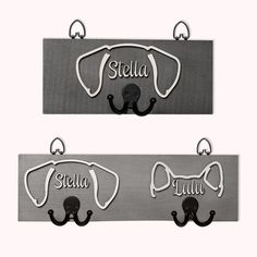 two metal dog leash hangers with name tags attached to them, one in black and the other in silver