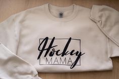 Introducing our "Hockey Mama" Crewneck - Available in the beautiful neutral colour "sand" 🏒 Are you the ultimate hockey mom? Show your pride with this cozy and stylish hoodie that's perfect for chilly game days or casual wear.  Crafted with love and dedication, this sweater is a must-have for any hockey lover. Features: *Comfortable and warm for those rink-side moments. *Available in sizes S to 2XL to suit every hockey mama. *Durable and easy to care for, so you can focus on what matters most: Mama Crewneck, Mom Crewneck, Mom Show, Hockey Gifts, Womens Sweatshirts, Mom Sweater, Hockey Mom, Gift For Mom, Game Day