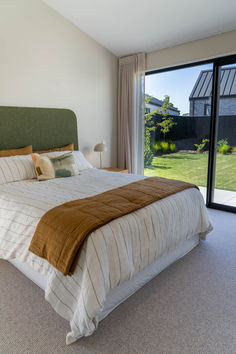 The master bedroom at 13 Oakbridge Boulevard, echoing the architectural elegance of the living area with scissor trusses, is a tranquil retreat bathed in natural light. 

A spacious walk-in wardrobe ensures ample storage for all your belongings. The ensuite is a masterpiece of design, adorned with beautiful terrazzo tiles, giving a sense of luxury. Tranquil Retreat, Plank Flooring, Outdoor Living Areas, Open Plan Living