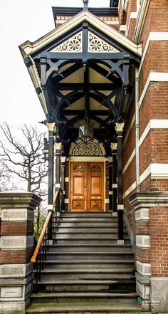 an old building with stairs leading up to the front door