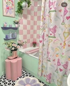 a bathroom decorated in pastel pink and green