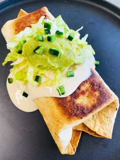 a plate with some food on top of it, including tortilla chips and guacamole