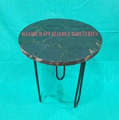 a small table with a sign on it that says, handcraft marbled industries