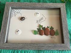 a shadow frame with buttons and leaves in it