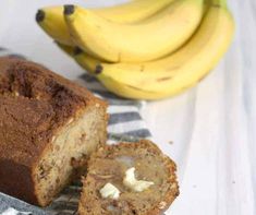 there is a loaf of banana bread next to some bananas