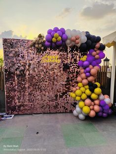 the balloon arch is decorated with many different colored balloons