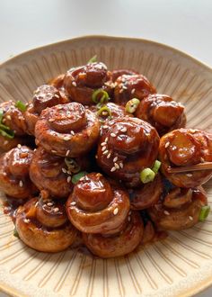 a plate full of food that includes meats and sesame seeds on the side, with a spoon in it