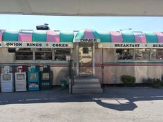 an old diner with colorful awnings and stairs