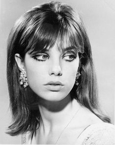 black and white photograph of a woman with long hair wearing large earring's