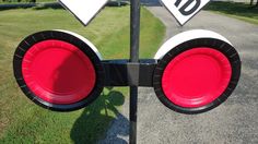 two red and white traffic lights sitting on the side of a road next to grass