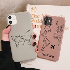 a woman holding up her phone case with a world map on it and an airplane drawn on the back