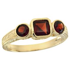 The ring features a vintage style, characterized by intricate detailing and a timeless aesthetic. The yellow gold setting offers a warm and rich backdrop for the gemstones. At the heart of the ring are three natural oval and cushion cut vibrant red garnets A perfect addition to any jewelry collection, this ring brings a touch of vintage charm to every special occasion. CHARACTERISTICS Status: Made to order Origin: Thailand Metal: Solid 9K Yellow Gold Ring Size: US 3-8 Total Gemstones Weight: 1.2 Three Rings, Timeless Aesthetic, Yellow Gold Setting, Three Stone Rings, Red Garnet, Ring Box, Three Stone, Cushion Cut, Yellow Gold Rings