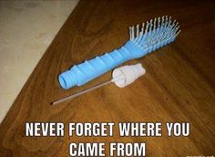 a blue and white hair brush sitting on top of a wooden table