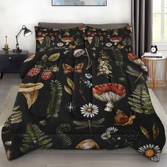 a bed covered in black and white flowers