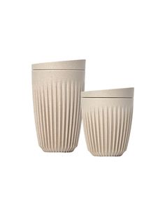 two white cups sitting next to each other