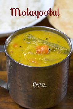 a close up of a pot of food on a table with the words molagotal in front of it