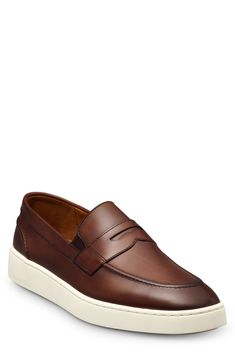 This leather slip-on sneaker with a bold rubber cupsole offers sleek hybrid styling with a loafer-inspired vamp complete with a penny keeper and moc-stitched toe. Slip-on style with elastic gore insets Leather upper and lining/rubber sole Imported Classic Brown Low-top Slip-ons, Classic Leather Loafers With White Sole, Classic Low-top Loafers For Business Casual, Classic Slip-on Sneakers With Leather Footbed, Classic Sneakers With Moc Toe And Contrast Sole, Classic Low-top Moccasins With Contrast Sole, Classic Slip-on Sneakers With Stitched Sole, Classic Leather Slip-on Sneakers, Classic Low-top Loafers With Removable Insole