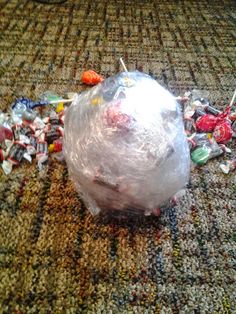 a plastic bag filled with candy sitting on top of a carpet