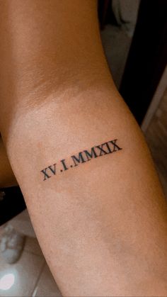 a person with a tattoo on their arm that says k v i mmxix