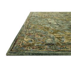 a green rug with an intricate design on the top and bottom, it is isolated against a white background