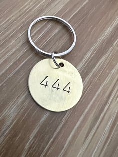 a metal keychain with the number forty four engraved on it's side