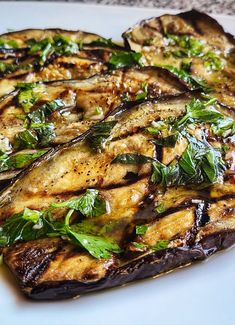 grilled eggplant and spinach on a white plate