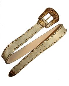 This belt features silver and Gold mixed studs on a champagne colored strap, finished with a gold plated Western buckle set. Vintage Sample! Minor wear. Sold AS IS. 1.5"W Genuine Leather Made in the USA Luxury Adjustable Gold Belt Buckle, Luxury Gold Adjustable Belt Buckle, Adjustable Gold Party Belt, Adjustable Gold Belt Buckle, Adjustable Gold Belt Buckles, Luxury Gold Belt For Party, Vintage Gold Belt Buckles, Embellished Belt, Western Buckles