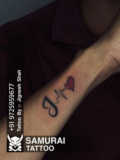 a man with a heart and heartbeat tattoo on his arm that says i love you